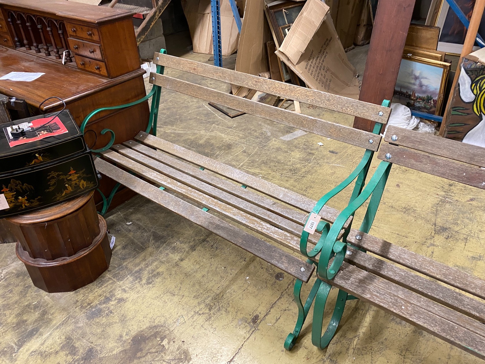 A near pair of painted wrought iron slatted wooden garden benches, larger length 137cm, depth 74cm, height 88cm